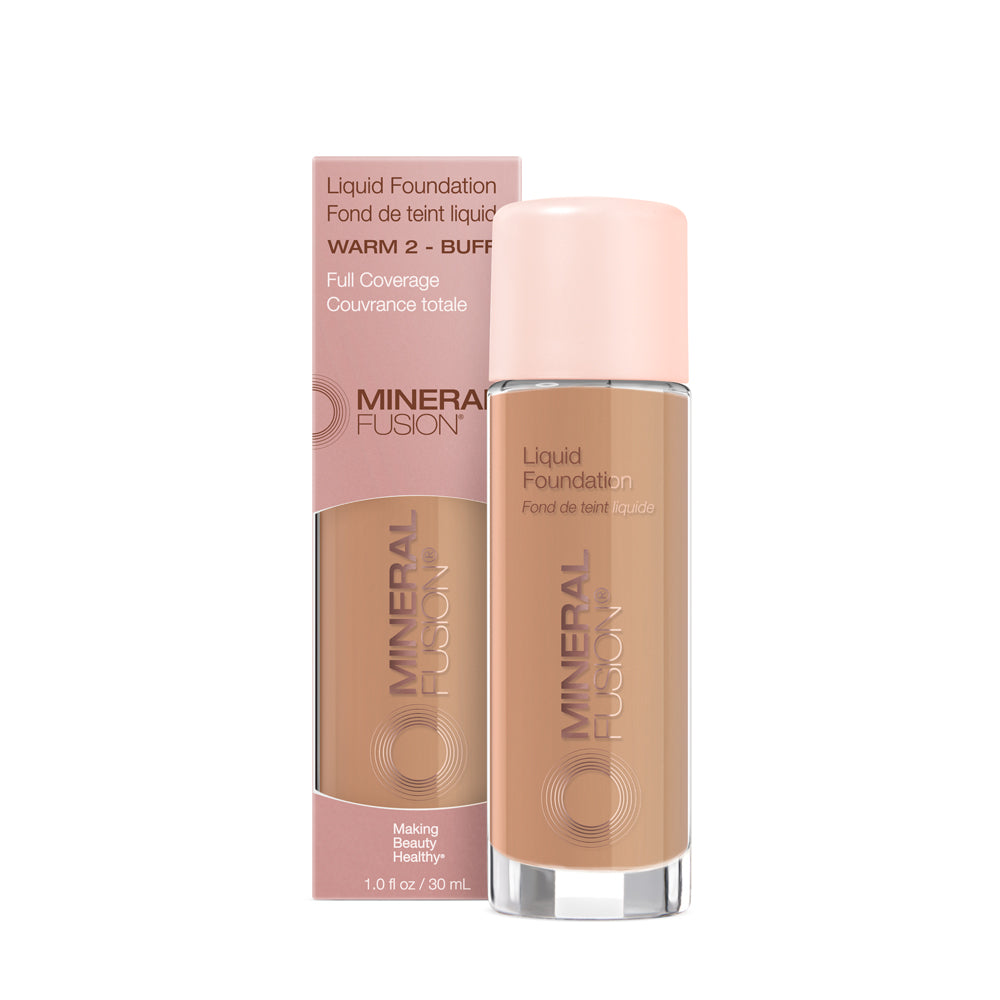 A pump bottle of liquid foundation branded 'Mineral Fusion' with its packaging box behind it. The foundation is displayed in a shade close to fair to medium skin tone range.