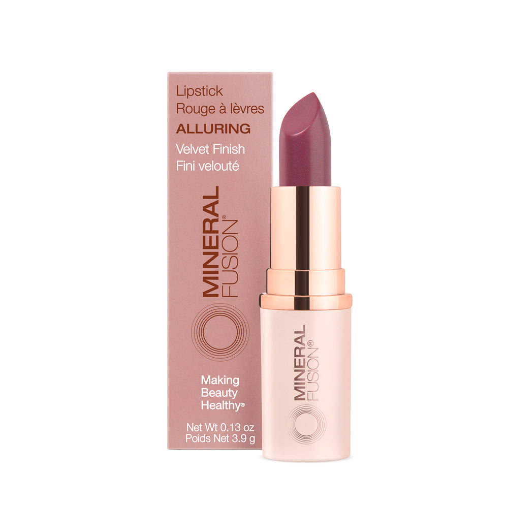 This image displays a stylishly packaged lipstick labeled "Alluring" by Mineral Fusion. The lipstick is presented in a sleek, rose gold tube with a smooth, purple hue that hints at the color inside.