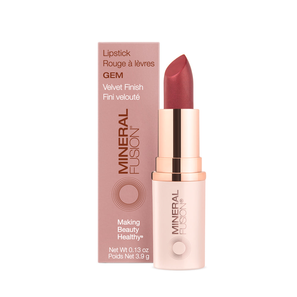This image displays a stylishly packaged lipstick branded "Gem," which is presented next to its matching pink box. The lipstick stick is encased in a sleek rose gold tube that adds an elegant touch.