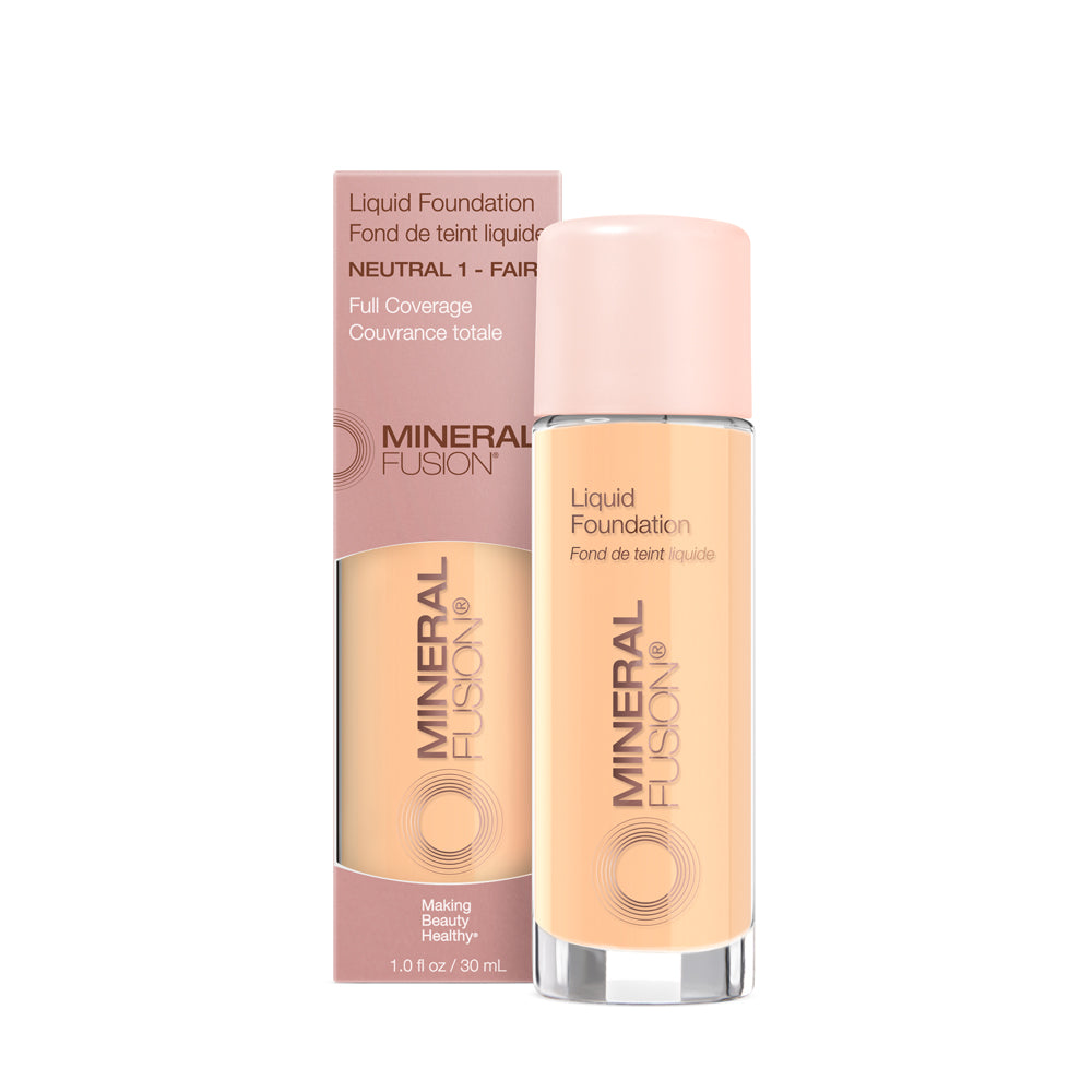 A pump bottle of liquid foundation branded 'Mineral Fusion' with its packaging box behind it. The foundation is displayed in a shade close to fair to medium skin tone range.