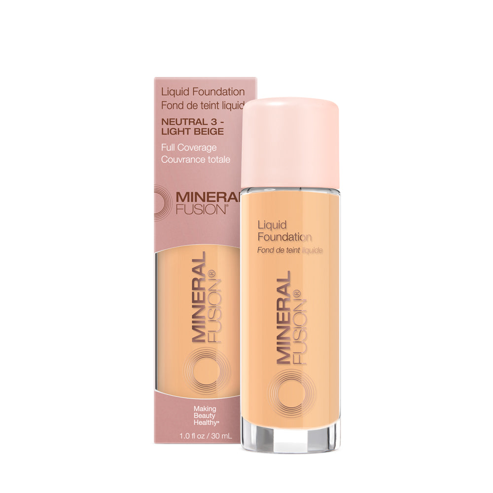 A pump bottle of liquid foundation branded 'Mineral Fusion' with its packaging box behind it. The foundation is displayed in a shade close to fair to medium skin tone range.
