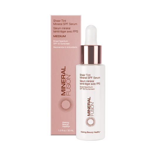 A bottle of Mineral Fusion Sheer Tint Mineral SPF Serum with its packaging box. The bottle is white with a pink dropper, and the box is pink with product information.
